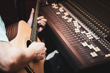 Sticker - close up male musician, composer playing acoustic guitar in studio. acoustic musical instrument recording or songwriting concept