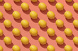 © Marc Tran/Stocksy - Many whole ripe yellow lemons on a seamless red background