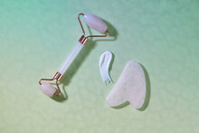 Cosmetic smear and jade face roller for beauty facial massage therapy.