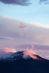 Wall Mural - Stunning view of snowcapped mountains during a beautiful sunset.