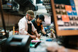 © Ezequiel Giménez/Stocksy - Colleagues preparing food in restaurant kitchen