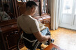 © Luis Velasco/Stocksy - Portrait Of Young Man With A Disability In Wheelchair At Home.