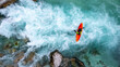 Drone shot of whitewater kayaker dealing with crystal clear rapids of Soca river in Slovenia 