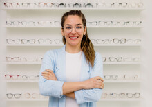 Smiling woman wearing eyeglasses in optic store