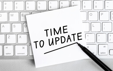 Poster - White paper with text Update lying on the keyboard