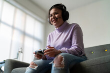 Cheerful Young Woman Playing Game Console