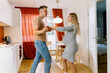 © Köt & Friends/Stocksy - Pregnant Couple Dancing In The Kitchen