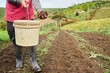 © J Esteban Berrío/Stocksy - Farmer fertilizing the soil