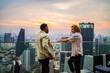 © Jovo Jovanovic/Stocksy - Two men having conversation at rooftop restaurant