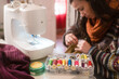 © Ibai Acevedo/Stocksy - Sewing accessories with blurred woman fixing handbag