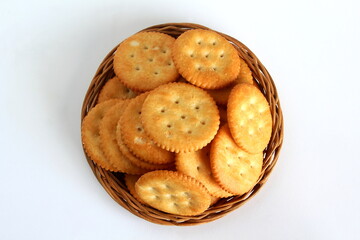 Wall Mural - round cracker biscuits or cookie isolated in basket,top view in white background