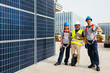© BONNINSTUDIO/Stocksy - Engineer with builders standing along solar power station