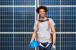 © BONNINSTUDIO/Stocksy - Engineer male smiling in front of solar power station