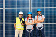 © BONNINSTUDIO/Stocksy - Engineers examining solar power station