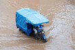 © Alvaro Lavin/Stocksy - motorcycle passing through flooded road in africa