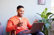 © ALTO IMAGES/Stocksy - Smiling black freelancer having video call