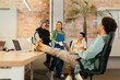 © BONNINSTUDIO/Stocksy - Diverse colleagues having informal meeting in office