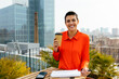 © BONNINSTUDIO/Stocksy - Smiling woman with coffee standing in terrace building