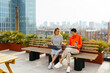 © BONNINSTUDIO/Stocksy - Female colleagues working together sitting in building terrace