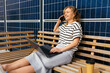 © BONNINSTUDIO/Stocksy - Cheerful woman talking on smartphone on building terrace