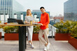 © BONNINSTUDIO/Stocksy - Smiling women working on table in a terrace building