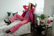 © Mauro Grigollo/Stocksy - Happy man in pink clothes at home