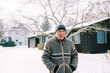 © Serena Burroughs/Stocksy - middle aged man in winter clothing outdoors after snow storm