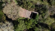 Aerial Rotating Rising Shot Of A Destroyed Roof On A Small Outhouse