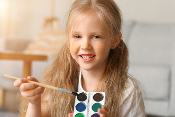 Wall Mural - Little girl with brush and watercolors at home