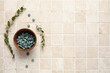 © Pixel-Shot - Bowl with pills and plant branches on beige tile background