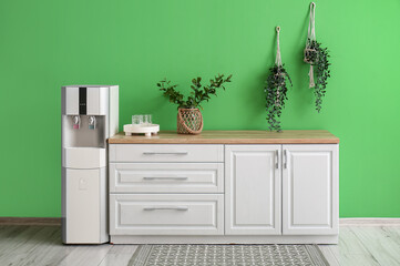 Poster - Interior of kitchen with modern water cooler near green wall