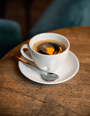 cup of coffee on table, in the cafe, black coffee, espresso with nice light on it, white cup 