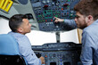© auremar - two men in aircraft cockpit apprentice asking a question