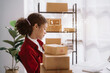 © NINENII - Startup or small business entrepreneur in e commerce, or logistics in remote startup at home. African American female owner selling online on the Internet, SME, shipping boxes, store success.