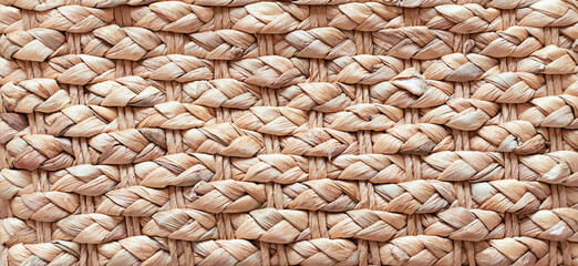 Beige straw woven texture pattern close up