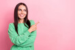 © deagreez - Photo of optimistic gorgeous woman straight hairdo dressed green sweatshirt look directing empty space isolated on pink color background