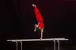 male gymnast performing on parallel bars competition artistic gymnastics, black background