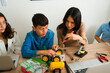 Teen friends assembling a robot prototype together