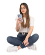 Using smartphone, caucasian woman using smartphone. Holding modern mobile phone with three cameras one hand. Sitting on the ground crossed legs. Isolated white background, copy space. Mobile app.