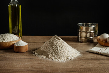 Wall Mural - Flour, salt and eggs for dough on wooden background