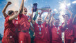 © Gorodenkoff - Football Finals Tournament Winning Team Celebrates Victory Cheering and Lifting Trophy Prize on Stadium. Happy Soccer Players Champions of International Championship Cup. Fireworks Shot.
