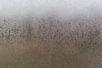 Wall Mural - Water droplets condensation background of dew on glass, humidity and foggy blank. Outside, bad weather, rain