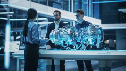 Fototapete - Smart Team of Engineers, Project Manager and Machinery Operators Collaborate on a New Type of a Electric Turbine Engine, Standing with Tablet and Laptop Computers in Scientific Technology Lab.