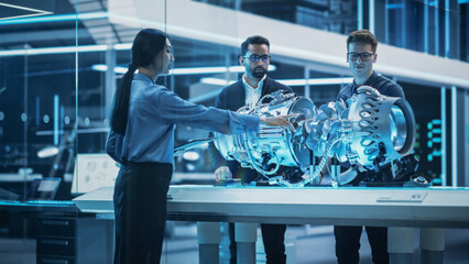 Fototapete - Software Developer, Project Manager and Machinery Operators Collaborate on a Prototype Turbine Engine, Standing with Laptop Computer in Scientific Technology Lab. Team Developing a New Electric Motor