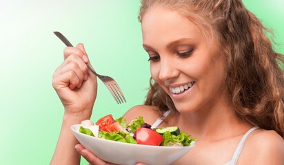 Wall Mural - Diet concept, young woman eat vegetables salad