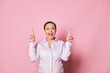 Amazed overjoyed surprised happy pregnant woman, gravid business lady pointing fingers up, posing with her mouth open, expressing amazement and positive emotions, isolated over pink color background