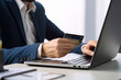© chandlervid85 - businessman making a purchase online with credit card. Ai generative