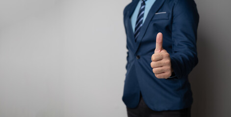 Close up view of Businessman showing a thumbs up sign with copy space.