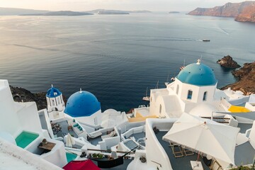 Canvas Print - The famous blue domes of Santorini. at sunrise