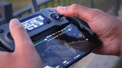 Close-up shot of hands controlling a drone controller